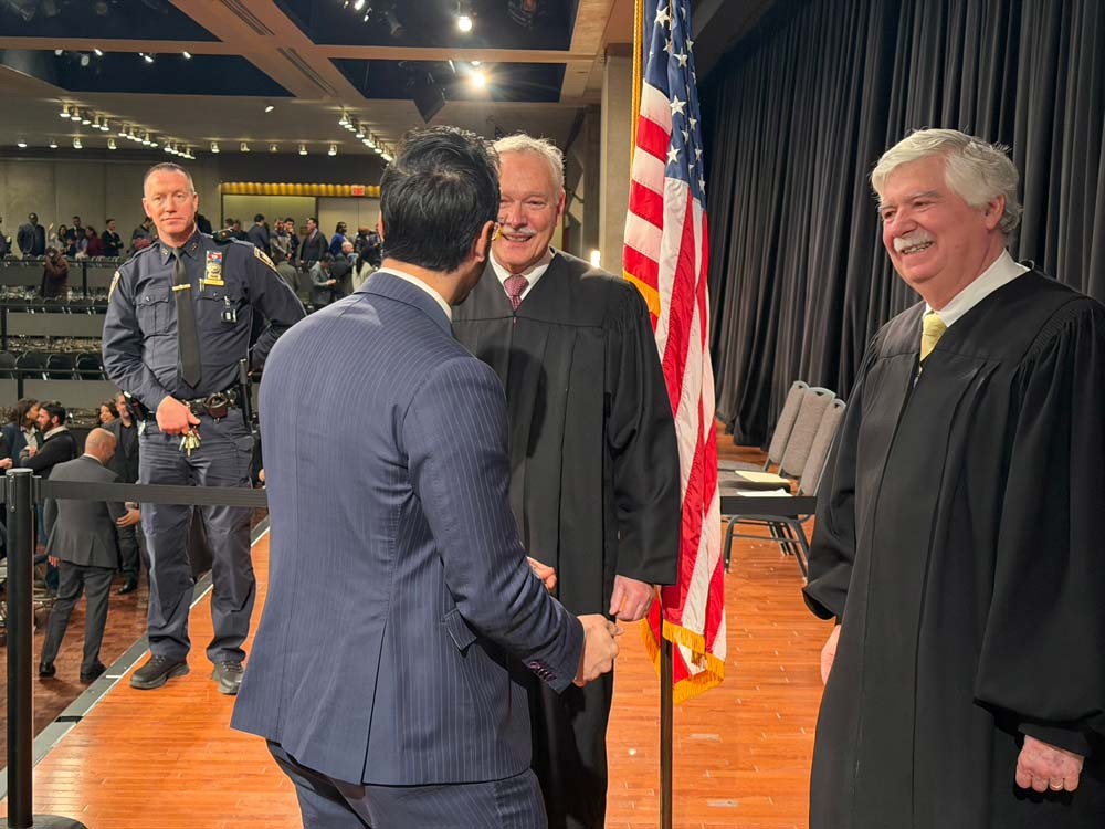 Shawn Lowe Desai shaking hands with two court judges